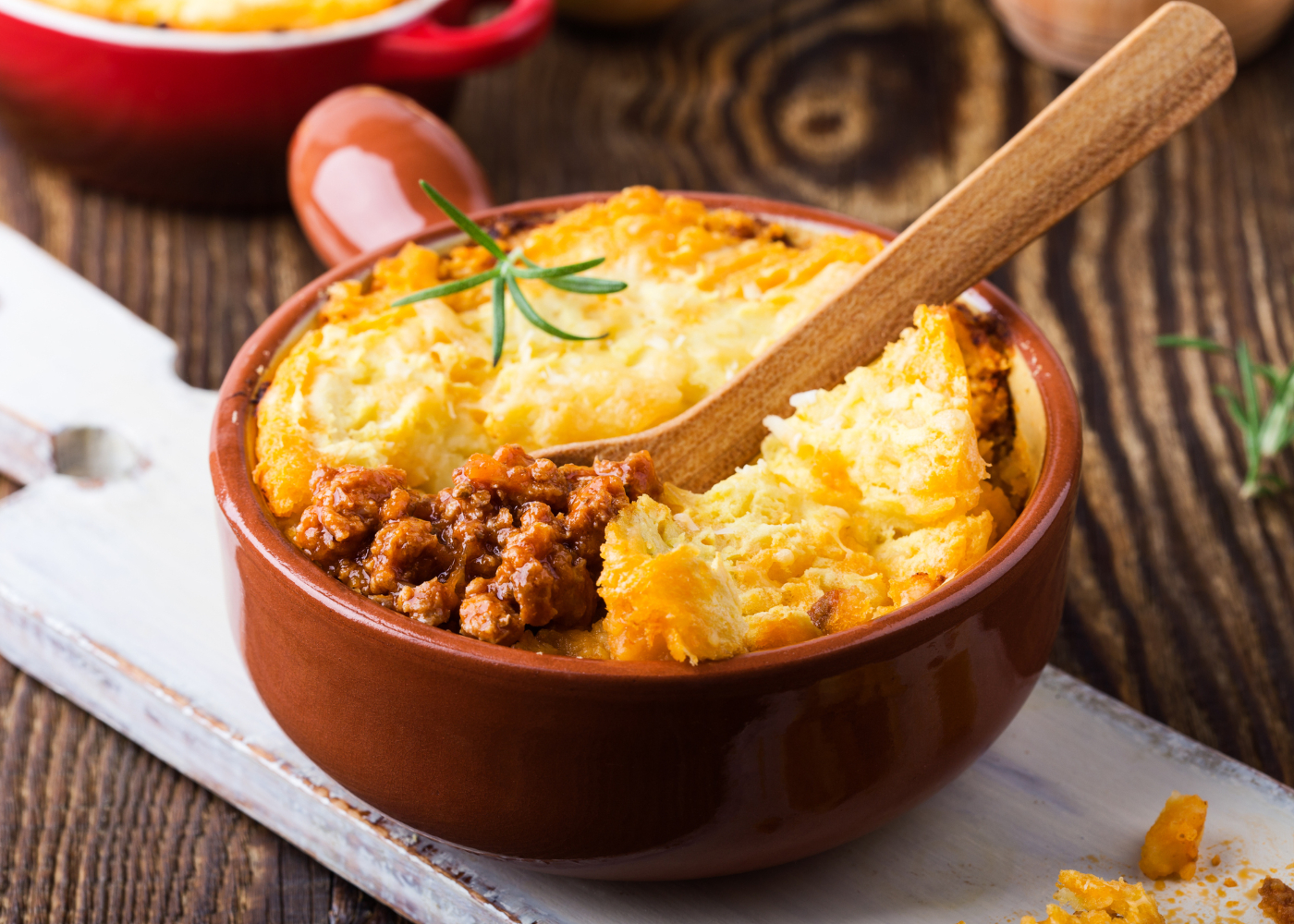 Shepherd's pie, traditional British dish with  minced meat and mashed potato on rustic wooden table